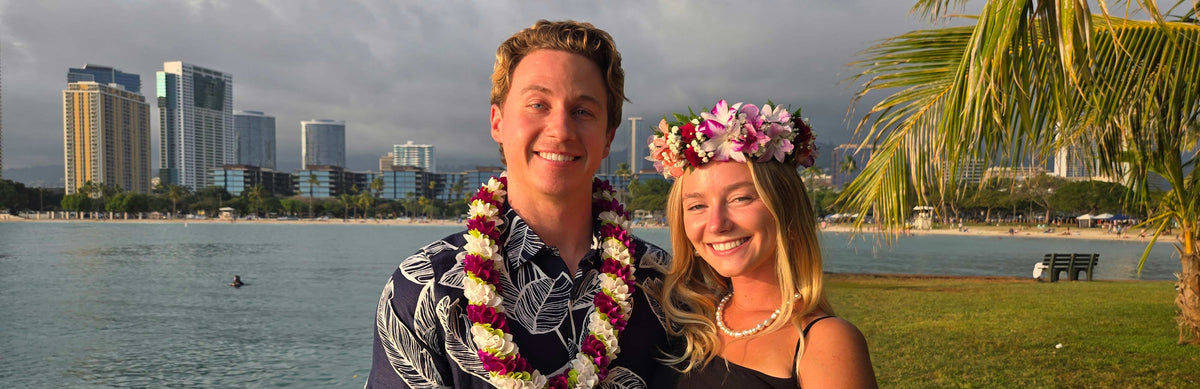 Couple wearing fresh Hawaiian wedding leis on a beach in Hawaii