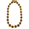Brown kukui nut lei with shell accents and ribbon tie