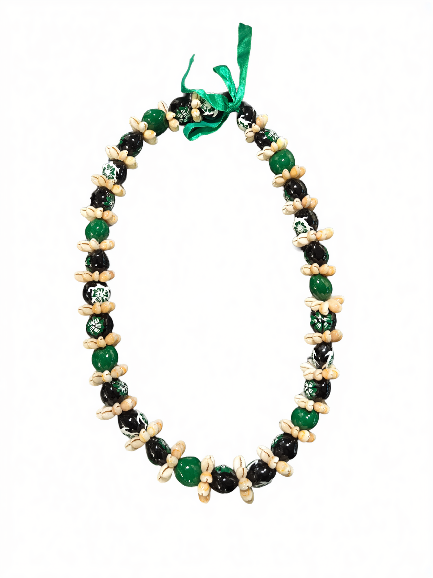 Green kukui nut lei with black beads and natural shell accents, isolated on white