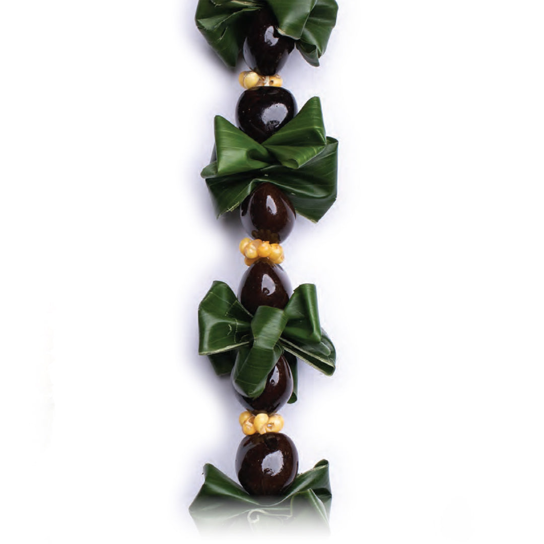 Ti Leaf & Kukui Lei of green ti leaf knots alternating with polished dark kukui nuts